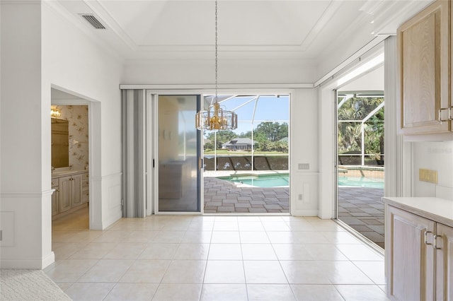 8 Dominica Dr, Englewood, FL 34223 - unfurnished dining area with a chandelier, crown molding, light tile patterned floors, and a raised ceiling