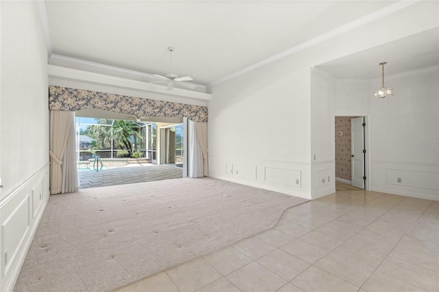 8 Dominica Dr, Englewood, FL 34223 - spare room with a decorative wall, crown molding, carpet, a ceiling fan, and tile patterned floors
