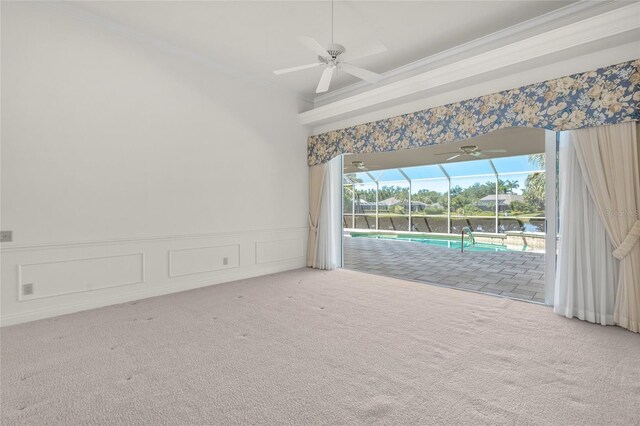 8 Dominica Dr, Englewood, FL 34223 - spare room with a sunroom, crown molding, carpet, a ceiling fan, and a wainscoted wall