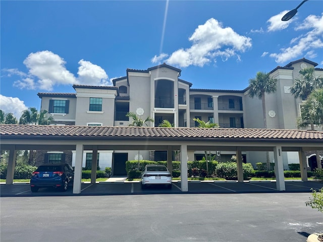 view of building exterior featuring covered parking