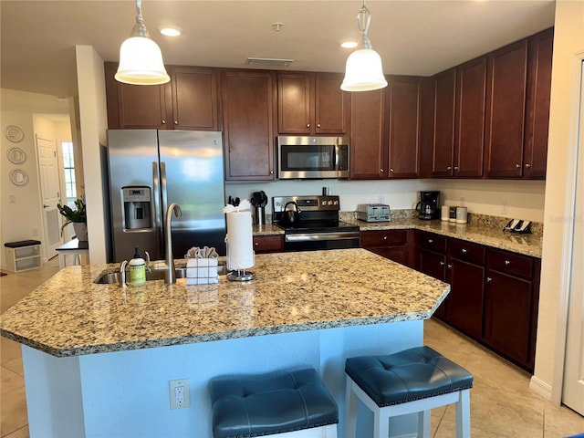 kitchen with stainless steel appliances, light tile patterned floors, light stone counters, and recessed lighting