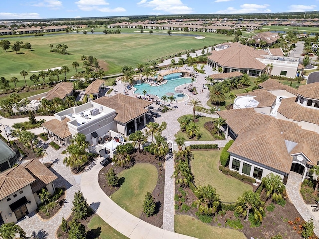 view of property location featuring a golf club, nearby suburban area, and a pool