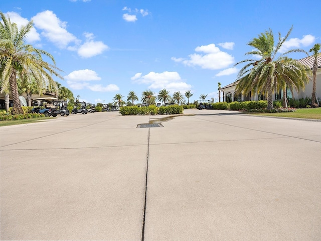 view of concrete street featuring curbs