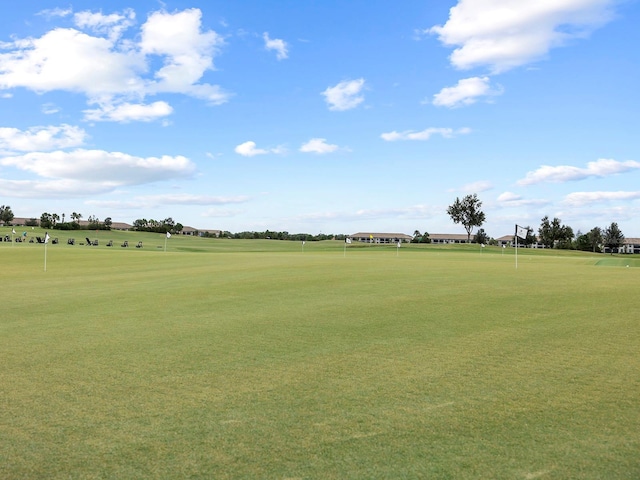view of property's community with golf course view and an area to practice putting