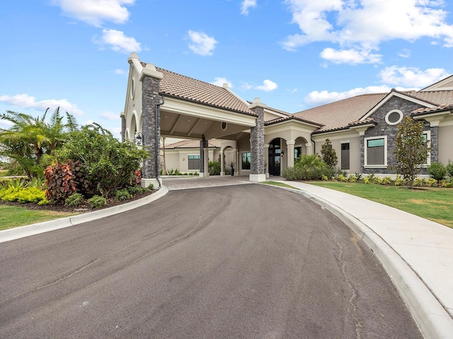 view of building exterior with curved driveway