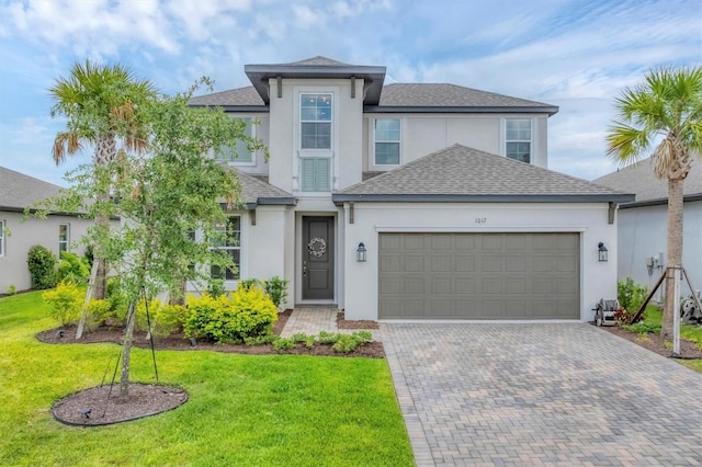 1017 Fernleaf Run, Bradenton, FL 34212 - view of front of home with stucco siding, a garage, decorative driveway, and a front lawn