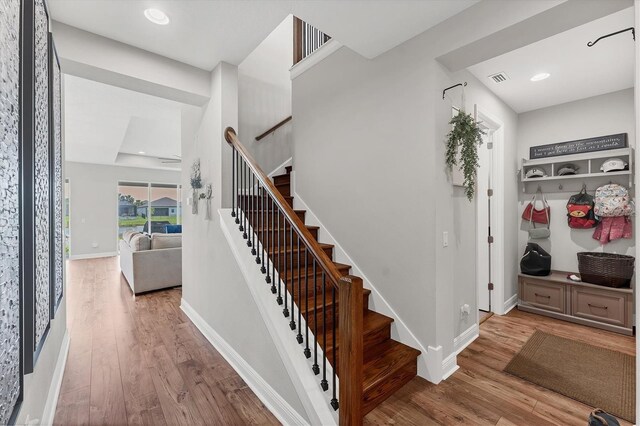 1017 Fernleaf Run, Bradenton, FL 34212 - staircase with wood finished floors, baseboards, and recessed lighting