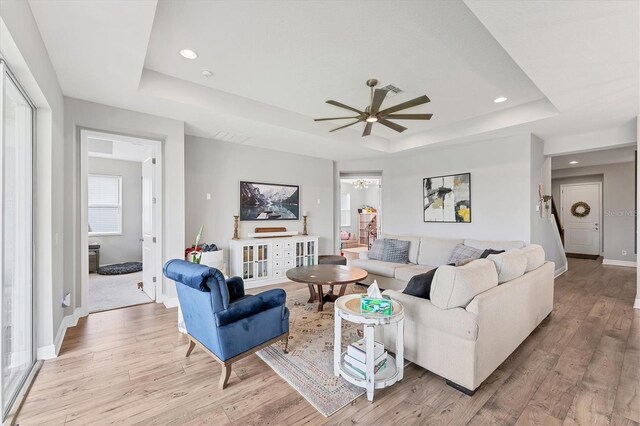 1017 Fernleaf Run, Bradenton, FL 34212 - living room featuring a raised ceiling, a ceiling fan, baseboards, light wood-style floors, and recessed lighting