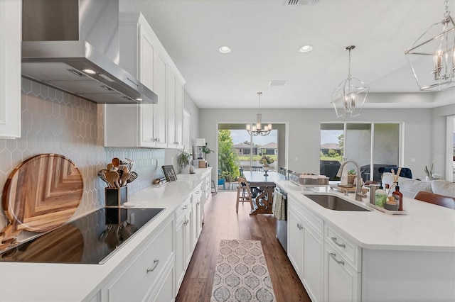 1017 Fernleaf Run, Bradenton, FL 34212 - kitchen featuring wall chimney range hood, a sink, black electric stovetop, dishwasher, and a chandelier
