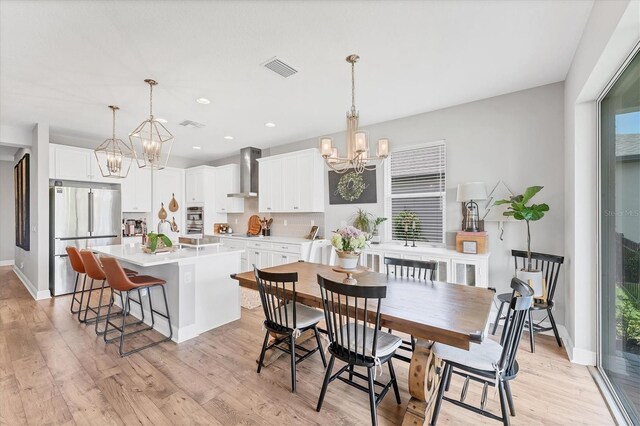 1017 Fernleaf Run, Bradenton, FL 34212 - dining room with a chandelier, light wood-style floors, baseboards, recessed lighting, and healthy amount of natural light