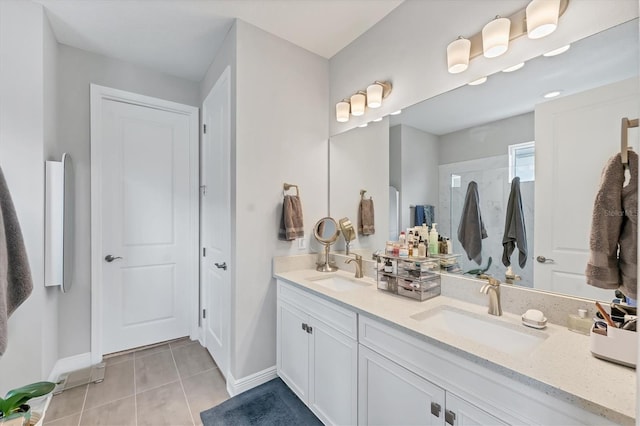 1017 Fernleaf Run, Bradenton, FL 34212 - full bathroom featuring tile patterned floors, double vanity, baseboards, and a shower