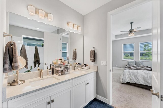1017 Fernleaf Run, Bradenton, FL 34212 - ensuite bathroom featuring ceiling fan, double vanity, and baseboards