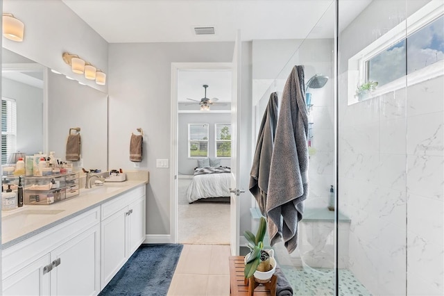 1017 Fernleaf Run, Bradenton, FL 34212 - ensuite bathroom with walk in shower, a ceiling fan, double vanity, tile patterned flooring, and baseboards