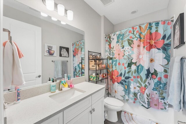 1017 Fernleaf Run, Bradenton, FL 34212 - full bathroom with toilet, vanity, and shower / bath combo with shower curtain