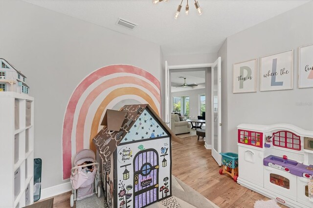 1017 Fernleaf Run, Bradenton, FL 34212 - recreation room featuring wood finished floors, baseboards, and ceiling fan