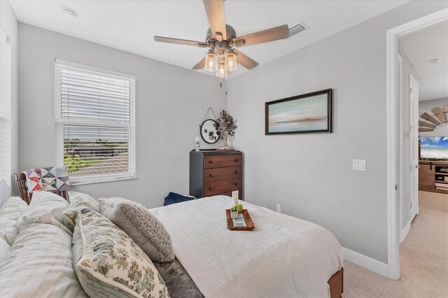 1017 Fernleaf Run, Bradenton, FL 34212 - bedroom with light colored carpet, baseboards, and ceiling fan
