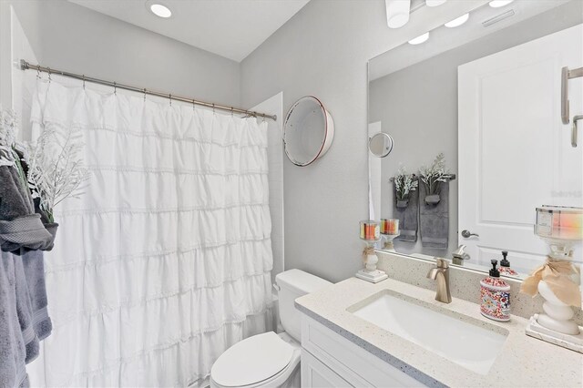 1017 Fernleaf Run, Bradenton, FL 34212 - bathroom featuring toilet, vanity, and a shower with shower curtain
