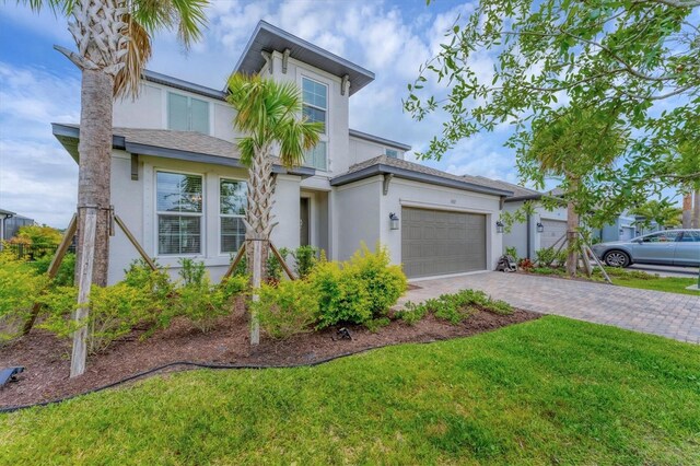 1017 Fernleaf Run, Bradenton, FL 34212 - view of front of property featuring stucco siding, driveway, a garage, and a front lawn