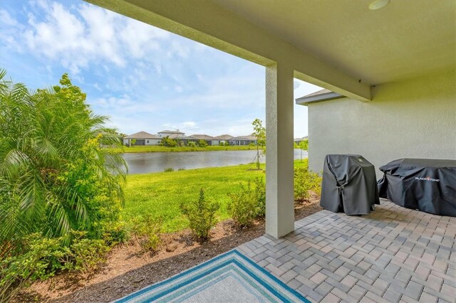 1017 Fernleaf Run, Bradenton, FL 34212 - view of patio with a water view, area for grilling, and a residential view