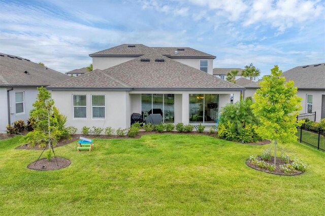 1017 Fernleaf Run, Bradenton, FL 34212 - rear view of house featuring a shingled roof and stucco siding