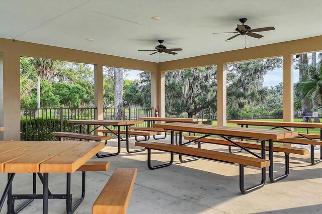 1017 Fernleaf Run, Bradenton, FL 34212 - unfurnished sunroom featuring view of wooded area and concrete floors