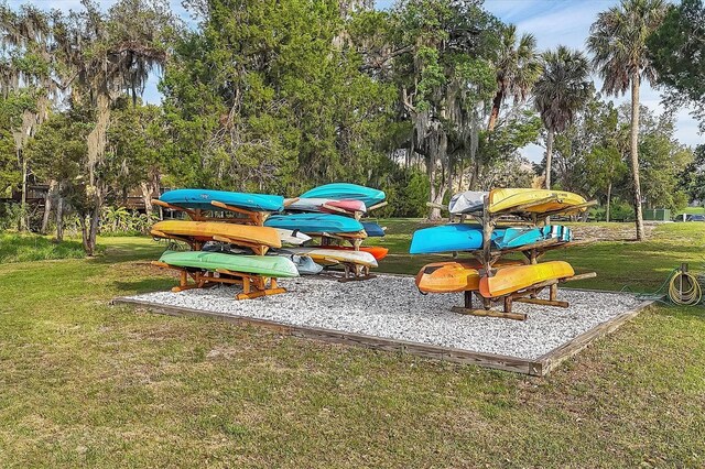 1017 Fernleaf Run, Bradenton, FL 34212 - view of jungle gym featuring a lawn and view of wooded area