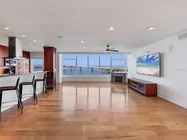 226 Golden Gate Pt Unit 63, Sarasota, FL 34236 - living area with ceiling fan, healthy amount of natural light, light wood-style flooring, recessed lighting, and baseboards