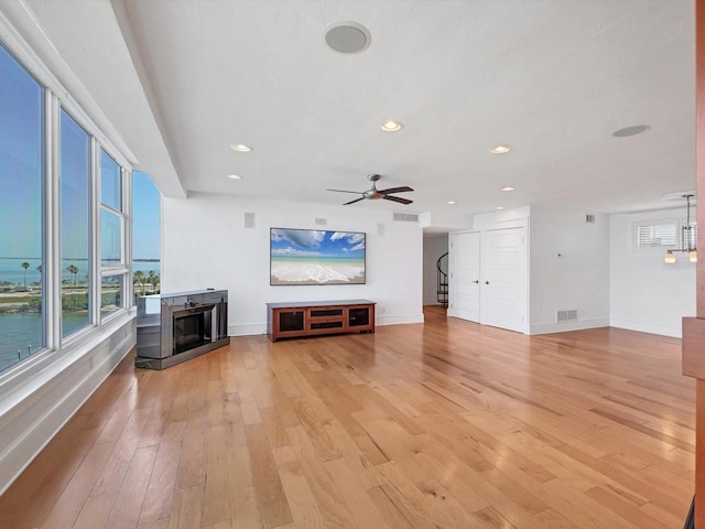 226 Golden Gate Pt Unit 63, Sarasota, FL 34236 - unfurnished living room featuring light wood-style floors, a fireplace, ceiling fan, baseboards, and recessed lighting