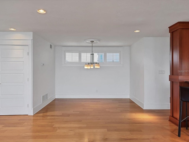226 Golden Gate Pt Unit 63, Sarasota, FL 34236 - unfurnished dining area featuring baseboards, recessed lighting, and light wood-type flooring