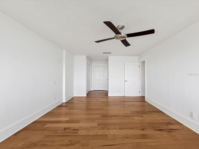 226 Golden Gate Pt Unit 63, Sarasota, FL 34236 - unfurnished bedroom featuring baseboards, light wood-style flooring, and a ceiling fan