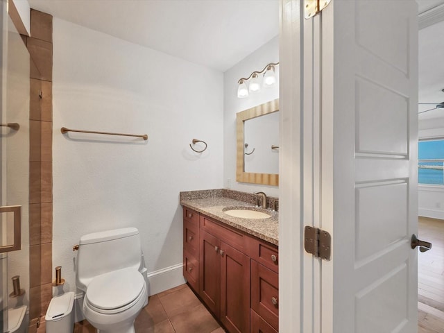 226 Golden Gate Pt Unit 63, Sarasota, FL 34236 - bathroom with vanity, toilet, baseboards, and tile patterned floors