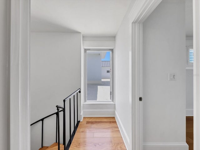 226 Golden Gate Pt Unit 63, Sarasota, FL 34236 - corridor with light wood-style floors, plenty of natural light, baseboards, and an upstairs landing