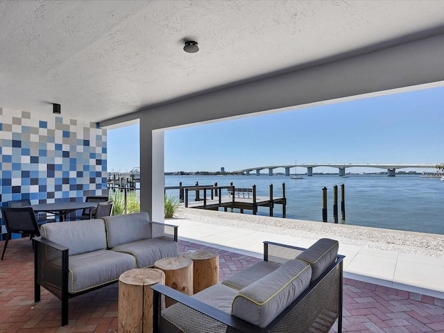 226 Golden Gate Pt Unit 63, Sarasota, FL 34236 - view of patio / terrace with a water view and outdoor lounge area