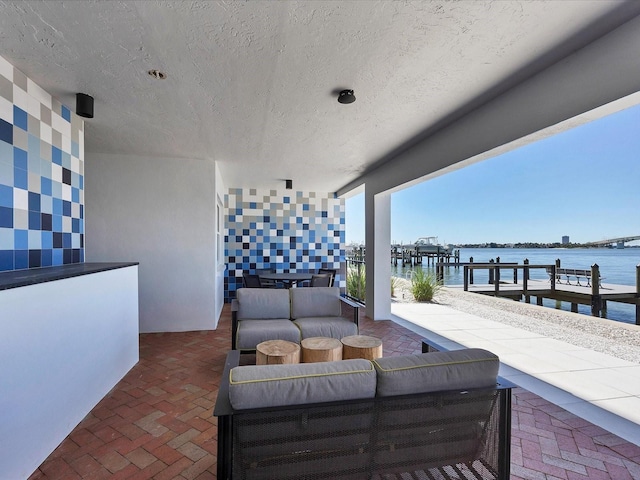 226 Golden Gate Pt Unit 63, Sarasota, FL 34236 - view of patio / terrace featuring a water view, outdoor lounge area, and a boat dock