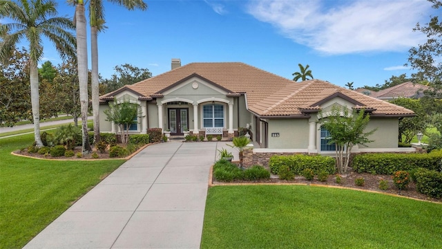 385 165th Ct NE, Bradenton, FL 34212 - mediterranean / spanish-style home with french doors, a tile roof, a chimney, and concrete driveway