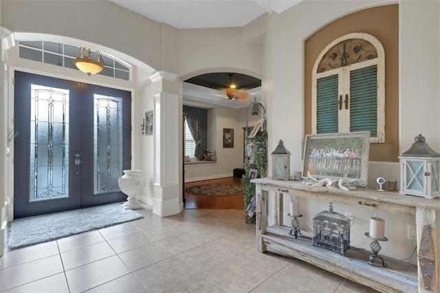 385 165th Ct NE, Bradenton, FL 34212 - entrance foyer with french doors, arched walkways, decorative columns, tile patterned flooring, and baseboards