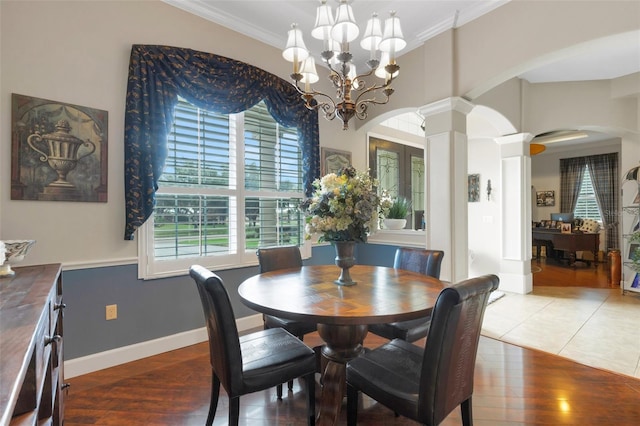 385 165th Ct NE, Bradenton, FL 34212 - dining space featuring arched walkways, ornate columns, ornamental molding, healthy amount of natural light, and a chandelier