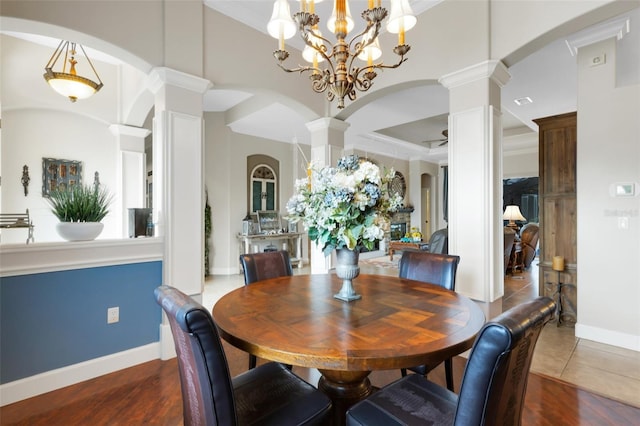 385 165th Ct NE, Bradenton, FL 34212 - dining space featuring decorative columns, arched walkways, a chandelier, and wood finished floors