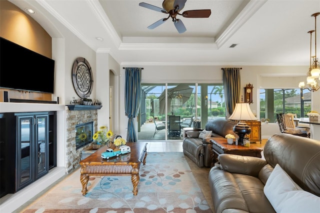 385 165th Ct NE, Bradenton, FL 34212 - living room featuring a ceiling fan, a fireplace, a raised ceiling, a chandelier, and ornamental molding