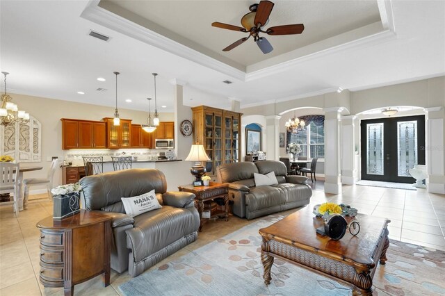 385 165th Ct NE, Bradenton, FL 34212 - living room with a chandelier, light tile patterned floors, ornate columns, arched walkways, and crown molding
