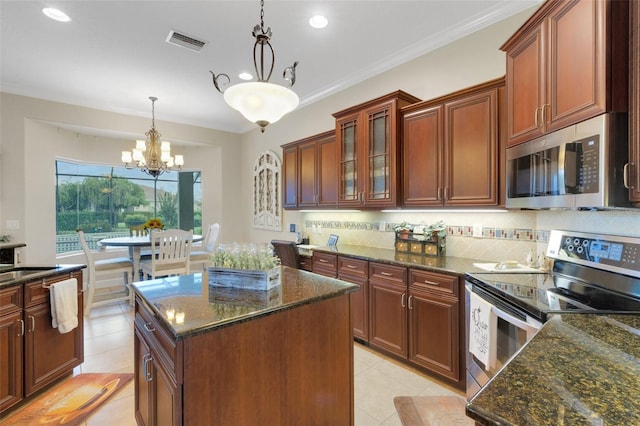 385 165th Ct NE, Bradenton, FL 34212 - kitchen featuring appliances with stainless steel finishes, light tile patterned floors, a chandelier, decorative backsplash, and recessed lighting