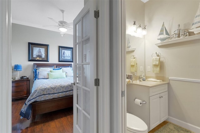 385 165th Ct NE, Bradenton, FL 34212 - ensuite bathroom with ceiling fan, wood finished floors, vanity, toilet, and baseboards