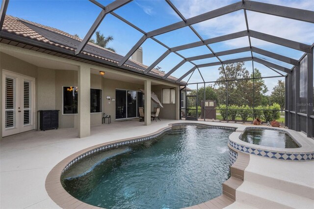 385 165th Ct NE, Bradenton, FL 34212 - view of pool featuring a patio area, a pool with connected hot tub, glass enclosure, and french doors
