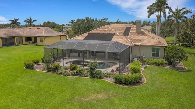 385 165th Ct NE, Bradenton, FL 34212 - back of house with a tile roof, a patio area, a lawn, an outdoor pool, and a chimney