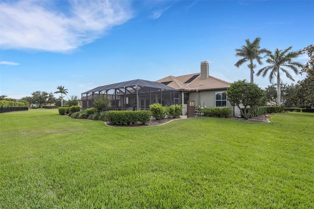 385 165th Ct NE, Bradenton, FL 34212 - back of house featuring a lawn, a chimney, stucco siding, and a lanai