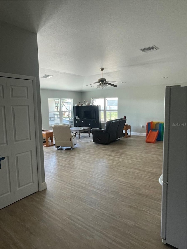5094 Bunyan St, Sarasota, FL 34232 - living area with plenty of natural light, ceiling fan, wood finished floors, and baseboards