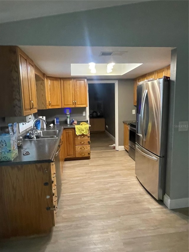 5094 Bunyan St, Sarasota, FL 34232 - kitchen with stainless steel appliances, a sink, baseboards, and dark countertops