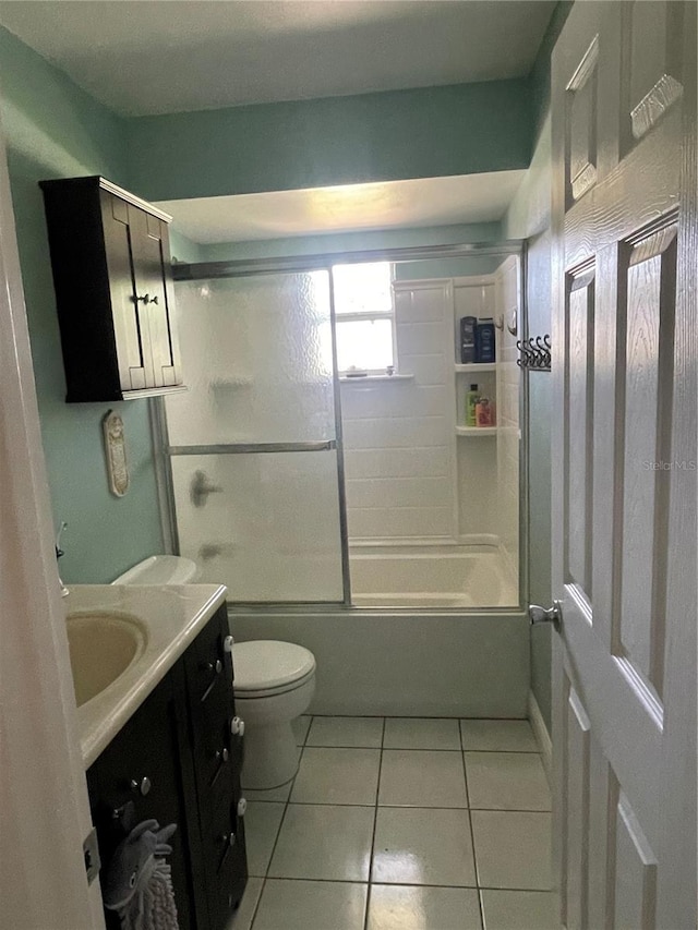 5094 Bunyan St, Sarasota, FL 34232 - full bathroom with tile patterned flooring, toilet, vanity, and combined bath / shower with glass door