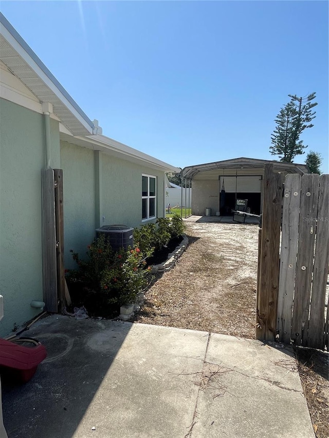 5094 Bunyan St, Sarasota, FL 34232 - view of patio / terrace featuring cooling unit, fence, and dirt driveway