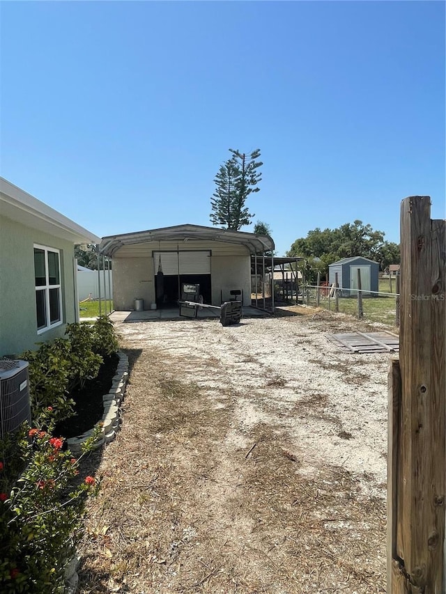 5094 Bunyan St, Sarasota, FL 34232 - garage with fence and central AC